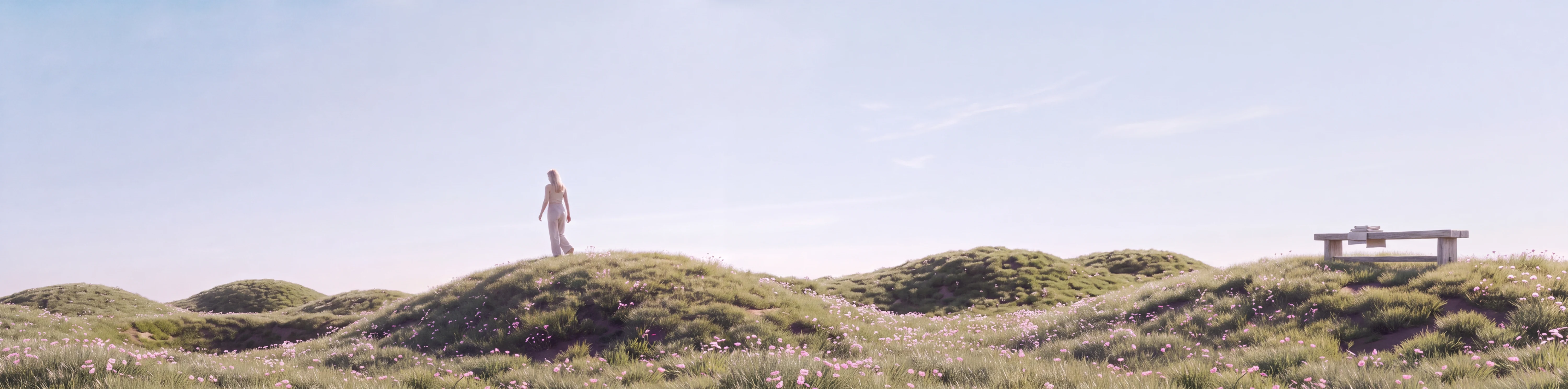 A continuous landscape of grassy mounds reveals a woman walking away, then a simple wooden bench.